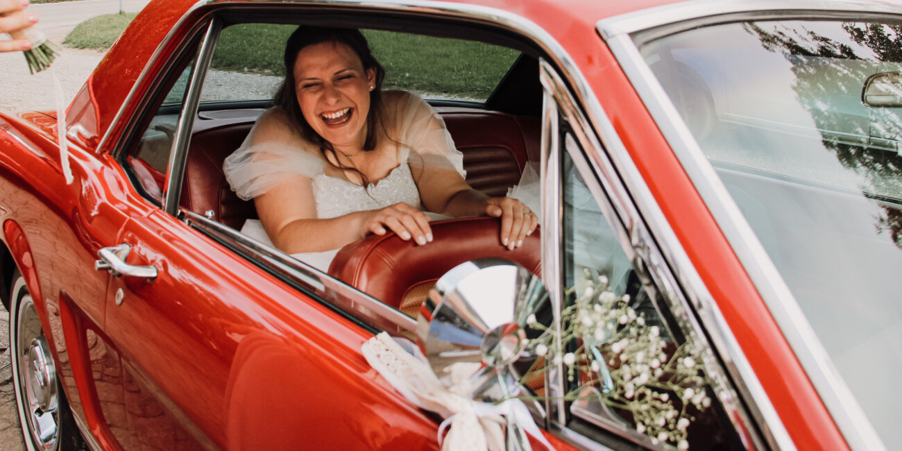 Bride in red car